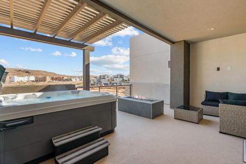 a large bathroom with a hot tub and a view at The Fish Bowl townhouse in St. George
