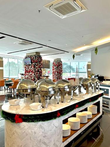 a restaurant with a bunch of dishes on a counter at 56 Hotel in Kuching