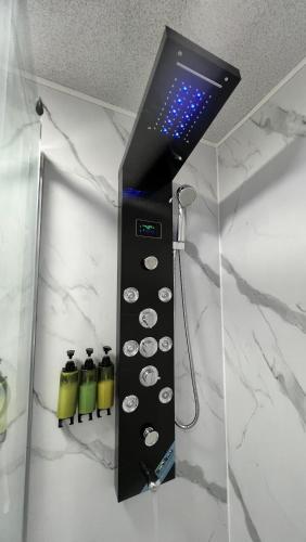 a control panel in a bathroom with four bottles at Sheffield Modern Studio with Free EV Charging in Sheffield