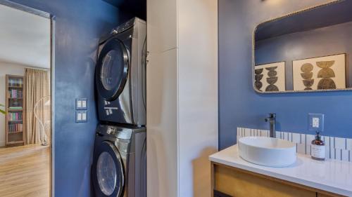 a bathroom with a sink and a washing machine at Walk to Beach Shops Fireplace Patio Dining Firepit at Manzanita Ave. in Manzanita