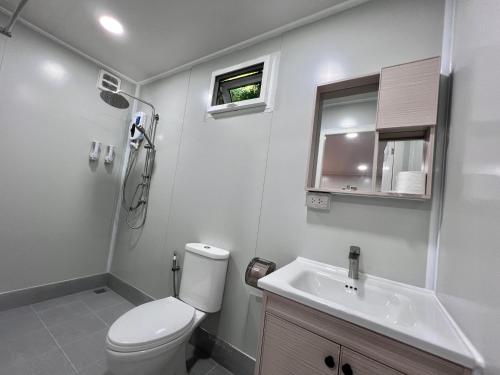 a bathroom with a toilet and a sink at The Green Resort in Ko Chang