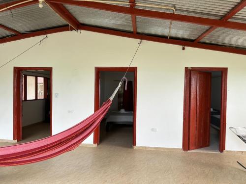 a hammock in the middle of a room with two doors at Finca hotel VillaLuna in Mesetas