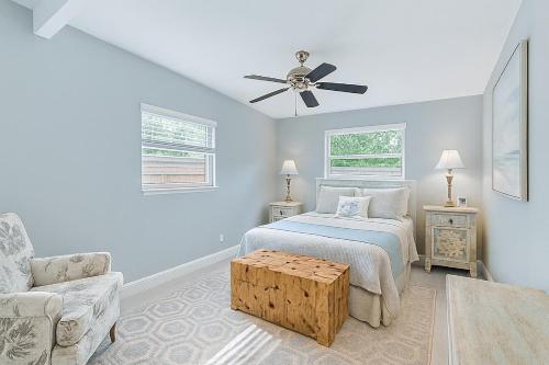 a bedroom with a bed and a ceiling fan at Tropical Pool Haven Minutes to Downtown & beaches in Naples
