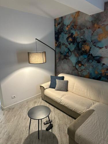 a living room with a couch and a table at Leyand exclusive House in Torre del Lago Puccini