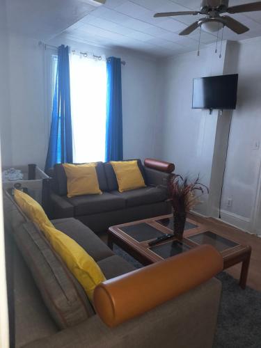 a living room with a couch and a table at Cozy downtown two bedrooms free parking in Kingston