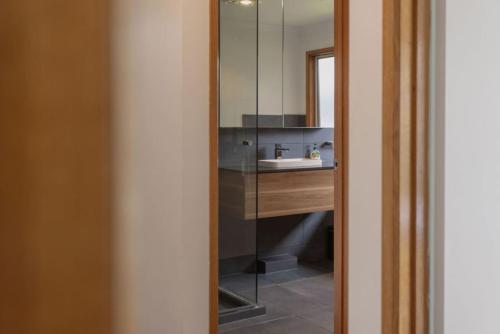 a bathroom with a sink and a mirror at The Balcony - pet friendly! in Torquay