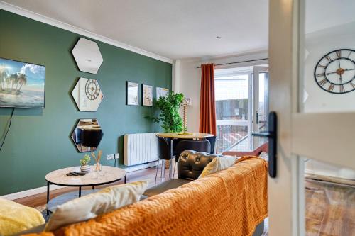 a living room with a couch and a table at New Slick Finnieston Pad w/ Free Parking in Glasgow