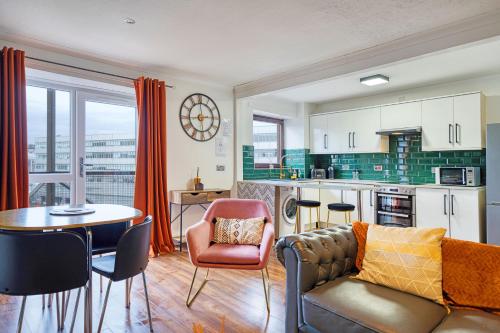 a living room with a couch and a table at New Slick Finnieston Pad w/ Free Parking in Glasgow