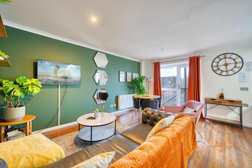 a living room with a couch and a table at New Slick Finnieston Pad w/ Free Parking in Glasgow