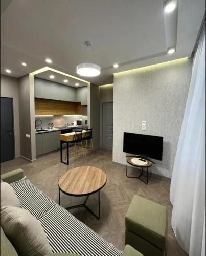 a living room with a couch and a table at Nice Stay Near Center in Yerevan