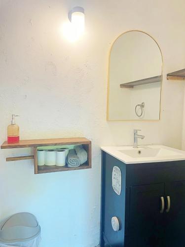 a bathroom with a sink and a mirror at 4 Amigos El Zonte in El Zonte