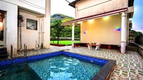 ein Swimmingpool im Hinterhof eines Hauses in der Unterkunft Zenzi Stays 11 BHK With 2 Pools in Khandāla