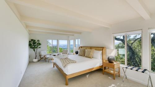 a bedroom with a bed and large windows at Sonoma Skyhouse by AvantStay Pool Sauna Hot Tub Stunning Valley Views in Sonoma