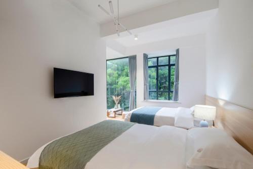 Ένα ή περισσότερα κρεβάτια σε δωμάτιο στο Sheng Hai Yun Ju