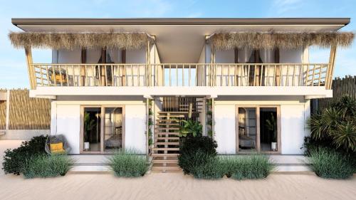 een wit huis met een balkon en een trap bij CozyShell in General Luna