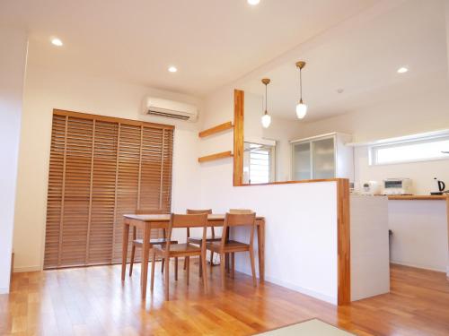 a kitchen and dining room with a table and chairs at Lulumalu AMAMI in Amami