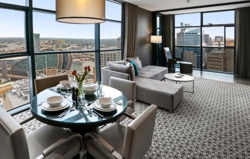 a living room with a table and chairs at Fraser Suites Sydney in Sydney