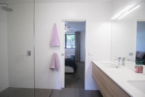 a white bathroom with a sink and a mirror at Lakes Edge 4 in Wendouree
