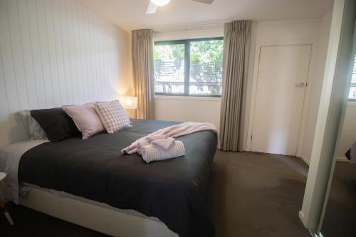 a bedroom with a bed with pink towels on it at Lakes Edge 4 in Wendouree