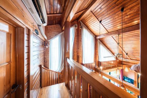 a room with wooden walls and windows in a cabin at AMANA ayurveda in Kami Amakusa