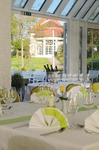 a table with wine glasses and napkins on it at Best Western Premier Parkhotel Bad Mergentheim in Bad Mergentheim