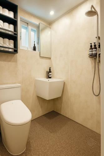 a bathroom with a toilet and a sink at Anguk House # Private 2F-3F Rooftop # Gyeongbokgung 1min # Bukchon in Seoul