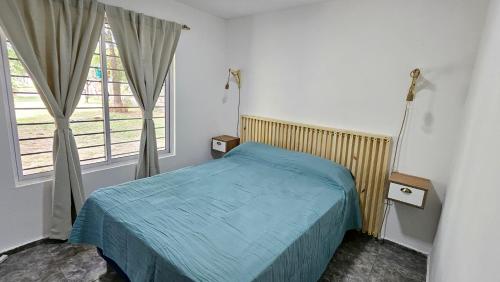 Giường trong phòng chung tại Complejo Ebenezer