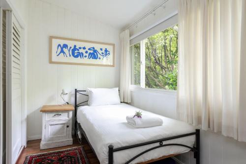 a small bedroom with a bed and a window at Finchley in Blackheath