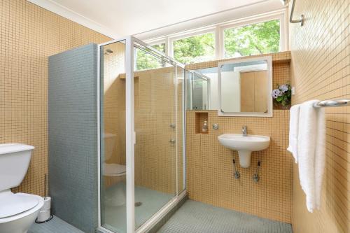 a bathroom with a shower and a sink at Finchley in Blackheath