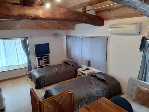 En eller flere senge i et værelse på みぃちゃの家 Casa di Micia おもや