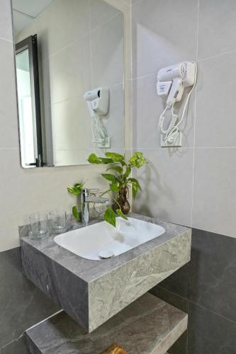 a bathroom with a sink and a mirror at Hiden An Hotel in Ninh Binh