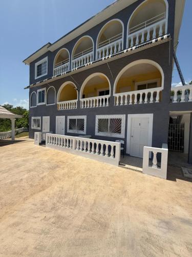 a large black building with a lot of windows at Superstar Living in Treasure Beach