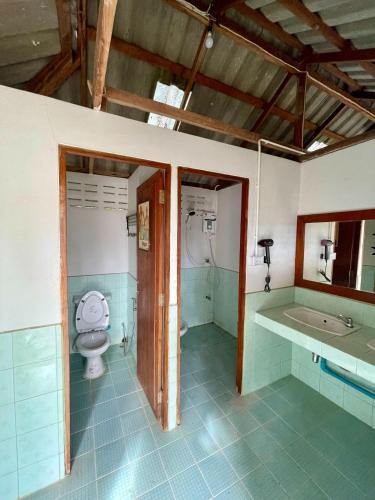a bathroom with a toilet and a sink at KNM Living Home in Pai