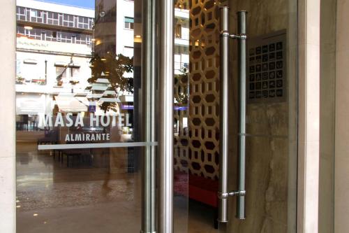 una puerta de cristal de un edificio con un cartel en THE Hotel MASA Almirante LISBON Stylish, en Lisboa