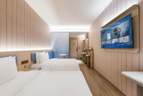 En eller flere senge i et værelse på Hanting Hotel Shanghai Gongkang Road Subway Station