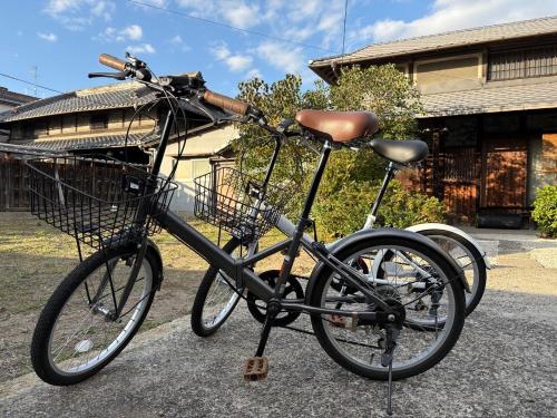 a bike with a basket is parked on the street at 藤花楼akagawa 登録文化財 in Osaka