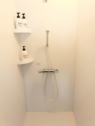 a bathroom with a shower with two shelves at Your Bedroom Hakone in Odawara