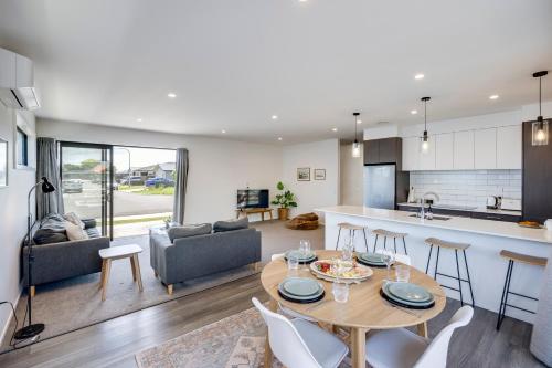 a kitchen and living room with a table and chairs at Quiet on Cassin - Taradale in Napier