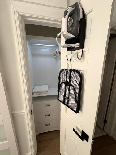 a walk in closet with a phone on the door at Charming Classic, duplex Home with a Modern Twist in Charlotte