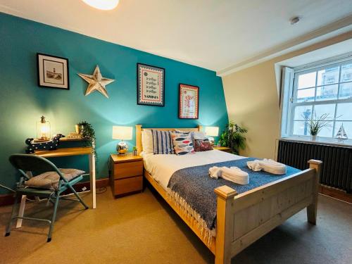 a bedroom with a bed and a desk and a star on the wall at Pebble Mews House By My Getaways Parking in Brighton & Hove