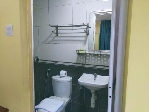 a bathroom with a toilet and a sink at Swing & Pillows - Sentul in Kuala Lumpur