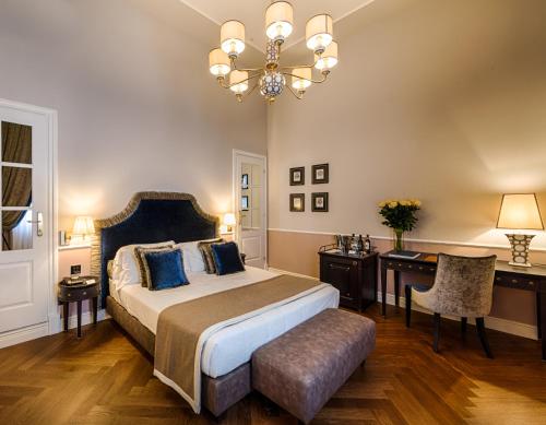 a bedroom with a large bed and a chandelier at Palazzo Roselli Cecconi in Florence