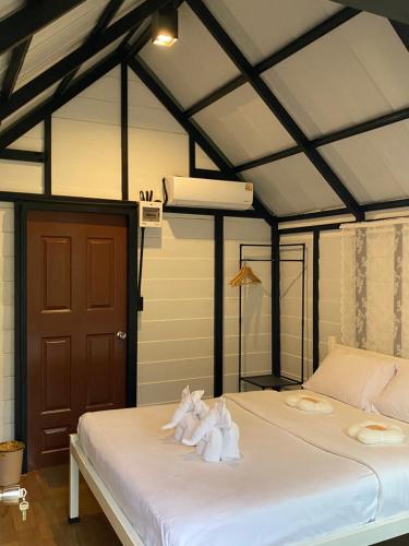a bedroom with a bed with towels on it at Lantamangrove in Ko Lanta