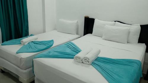 Ένα ή περισσότερα κρεβάτια σε δωμάτιο στο Hotel Mendoza Inn