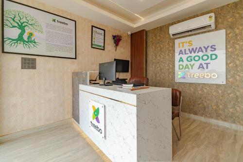 a lobby with a reception desk and a sign at Treebo KGF Villa with Swimming Pool in Prayagraj