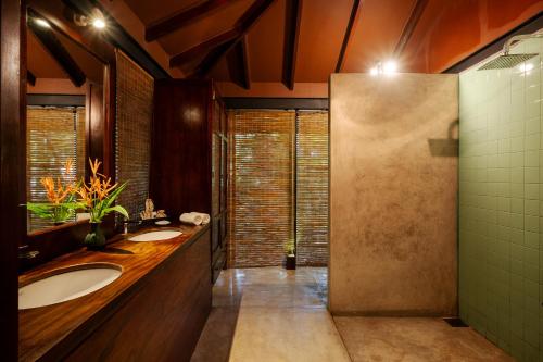 a bathroom with two sinks and a shower at Jetwing Kurulubedda - Adults Only in Galle