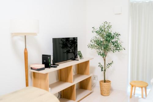 a living room with a tv on a shelf at Greenfield - Vacation STAY 20422 in Sasebo