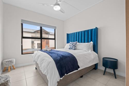 a bedroom with a large bed and a window at 356 Ballito Hills in Ballito