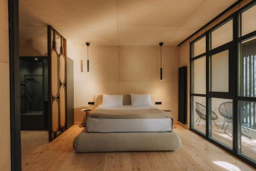 a bedroom with a bed and a large window at Kiketi Farm in Kiketʼi