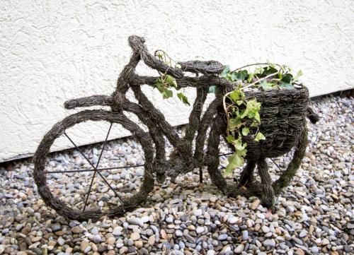 a plant in a basket on top of rocks at Hotel Garni Krone in Senden